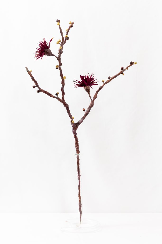 Solstice Branch with dark maroon blooms and gold berries on bare wood