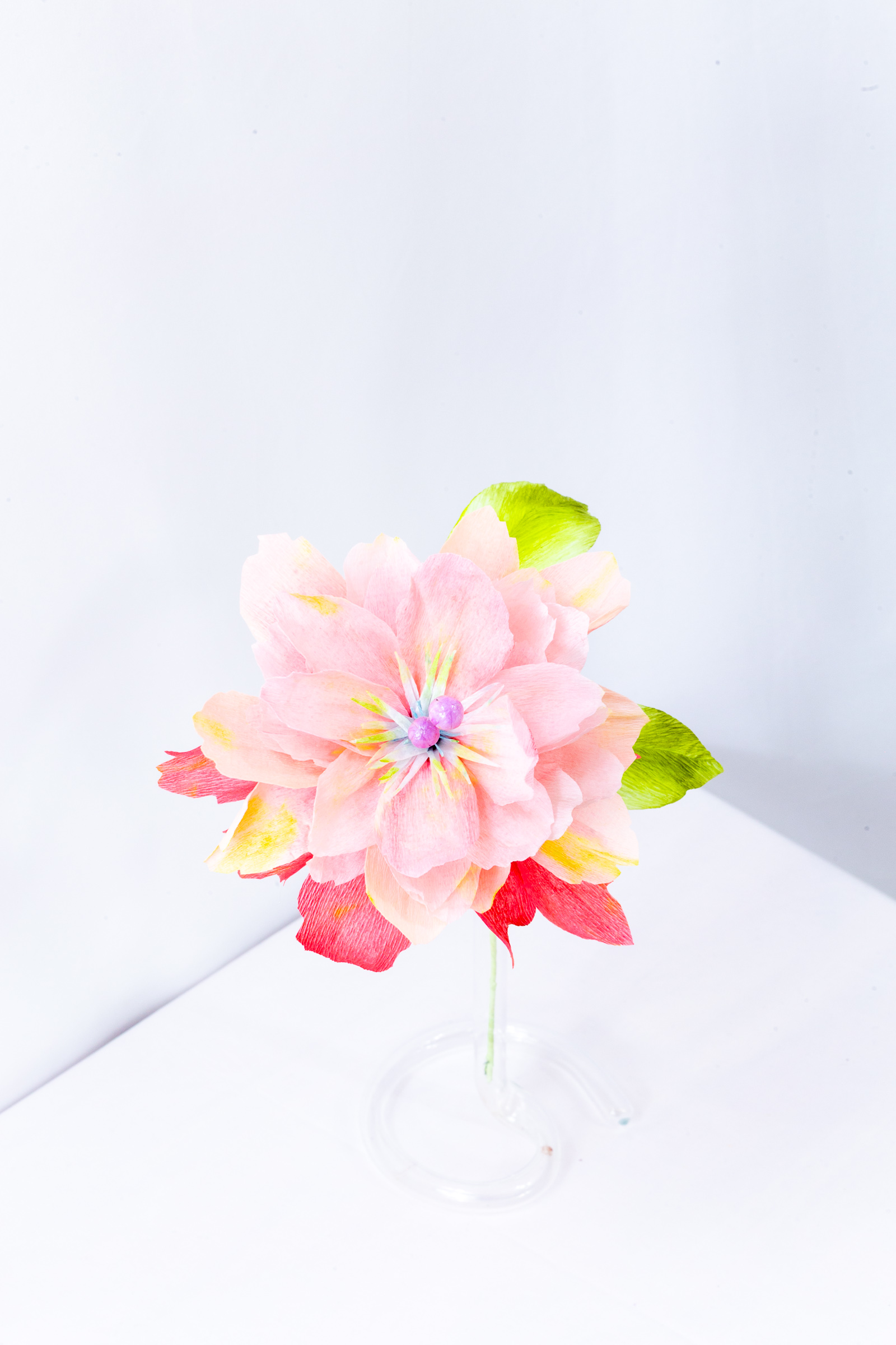 Moonberry Peony with hand-dyed red and peach petals and two lavender orbs rising from the center